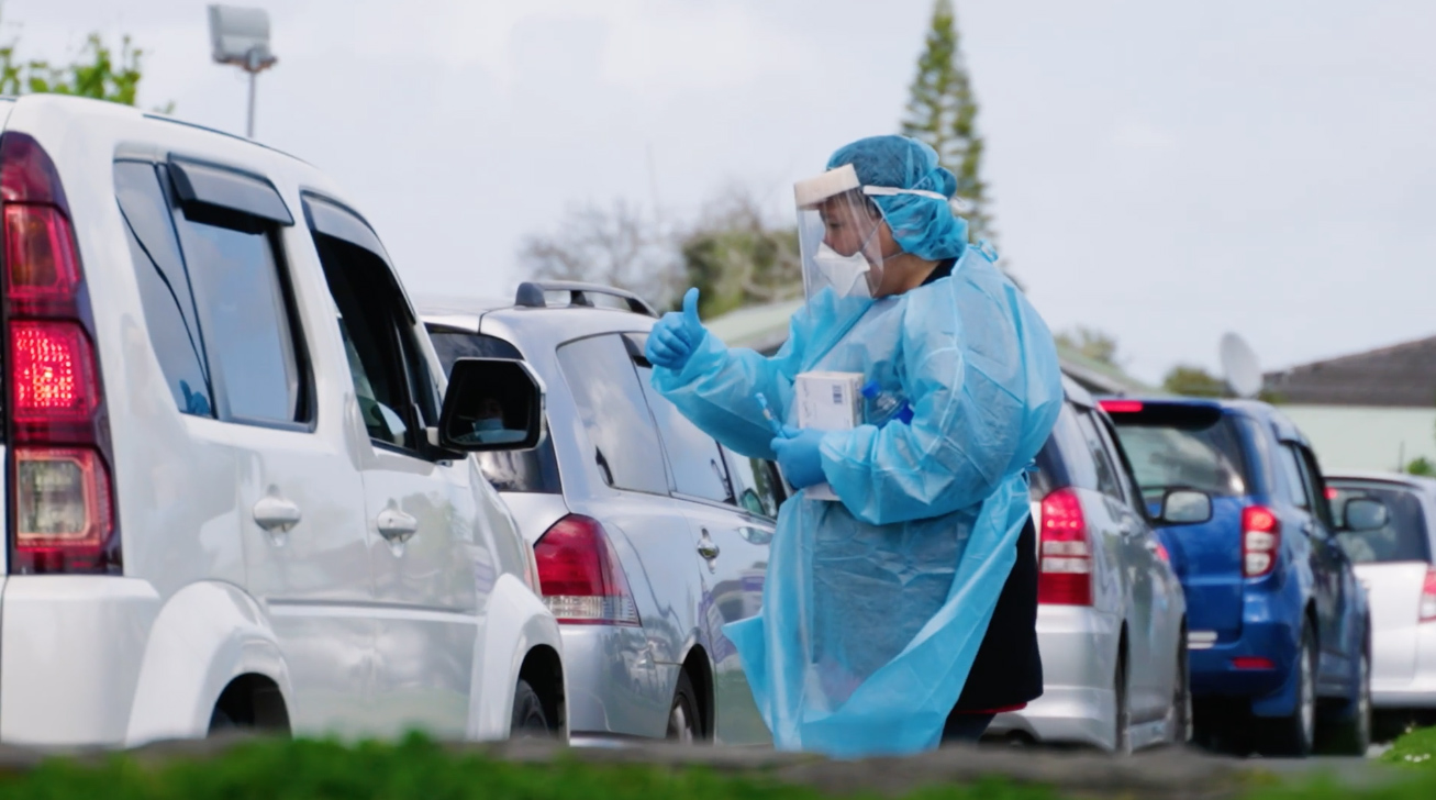 Health worker providing drive through vaccinations